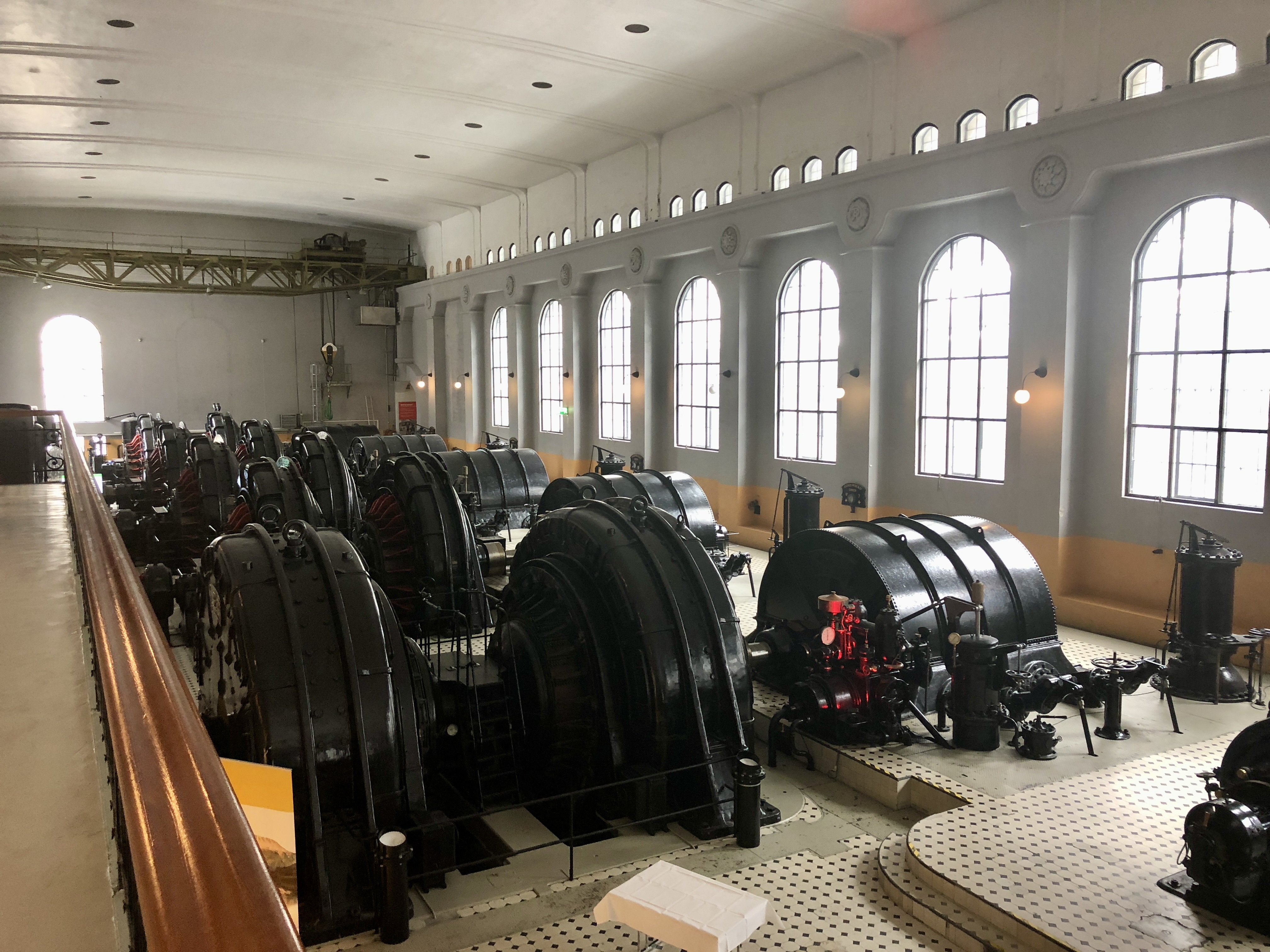 Turbinhallen på Vemork med rader av historiska generatorer och höga bågfönster